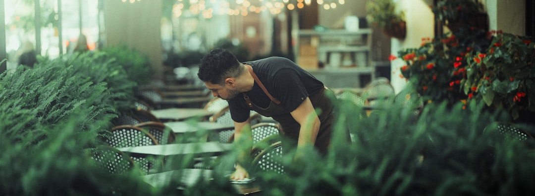 man-tending-to-lush-green-plants-indoors-0drnpwd1mry